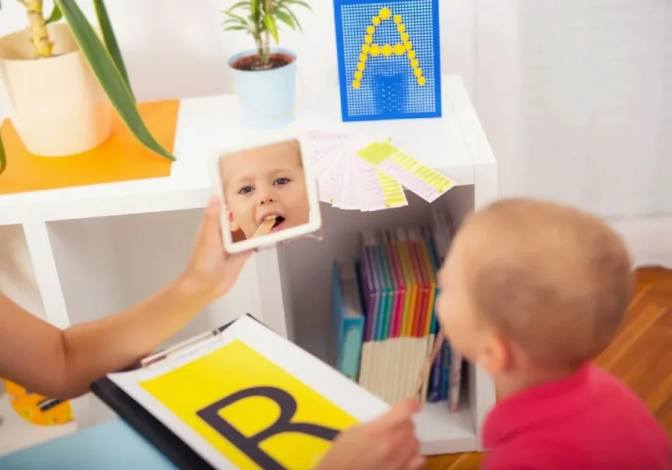 A child looking at his reflection in the mirror.